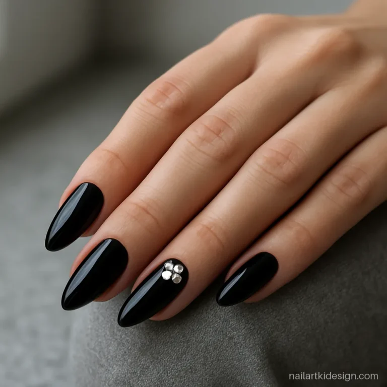 Black silver nail art with small silver stones on the ring finger