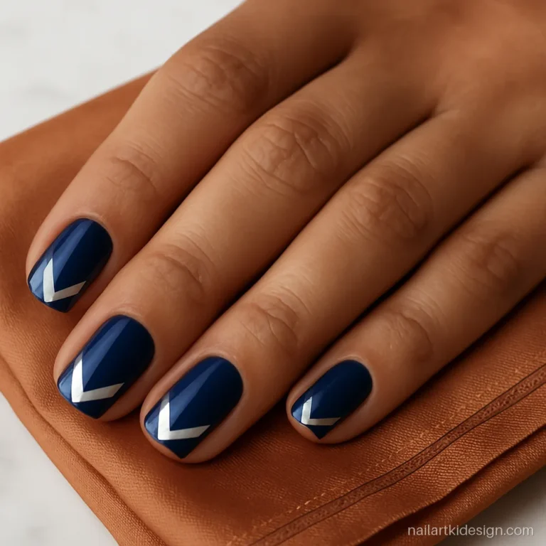 Navy nails with silver chevron tips made with two pieces of tape