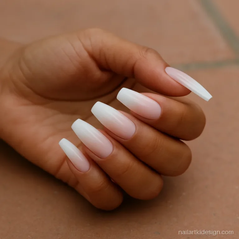 Ombre nail extensions fading from pink to white on long coffin nails
