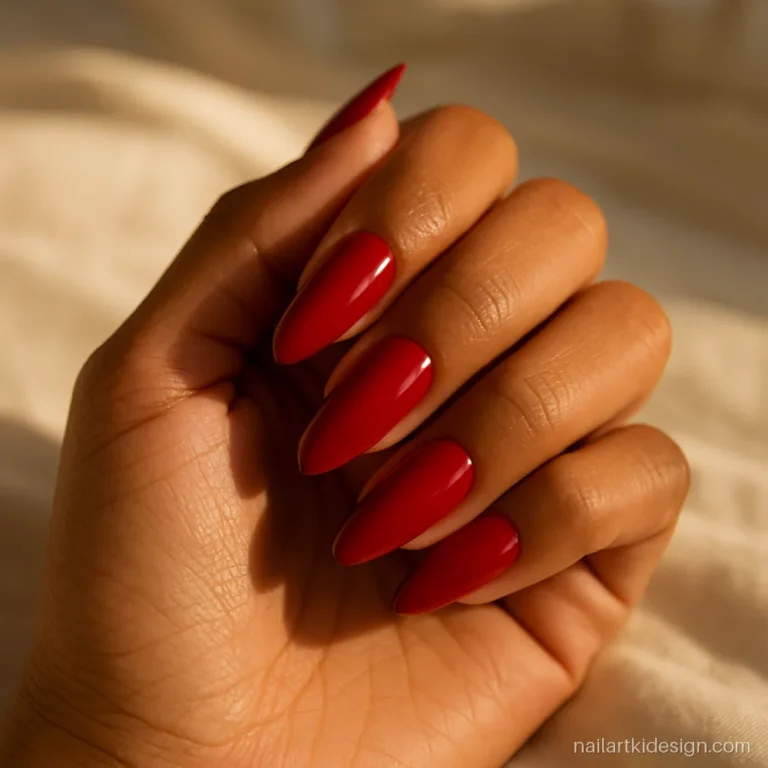 Red nail extension designs in glossy classic red on long almond nails