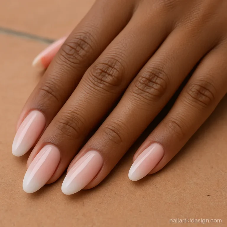 Baby boomer French ombre nails fading from pink to white on medium almond nails