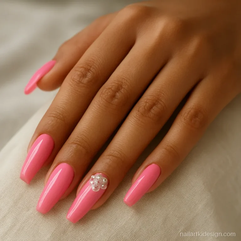 Pink coffin nails with a cluster of stones and pearls on the ring finger