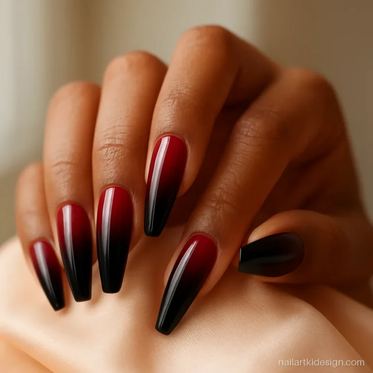 Red and black ombre nails on long coffin nails with a glossy finish