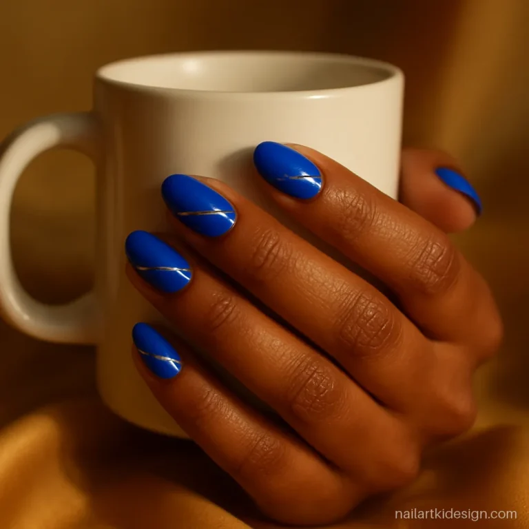 Royal blue nail art with thin silver stripes on medium almond nails