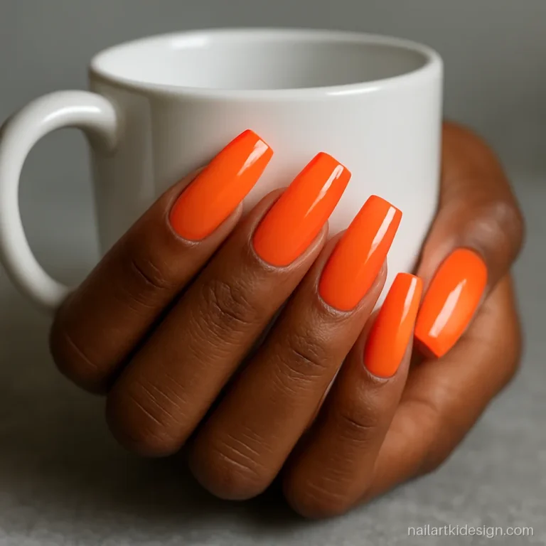 Orange nail designs with tangerine base and coral tips on coffin nails