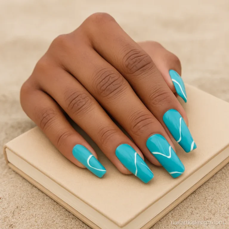 Beach nail art with white wave lines over ocean blue on coffin nails